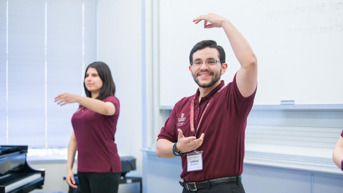 Two people doing hand movements