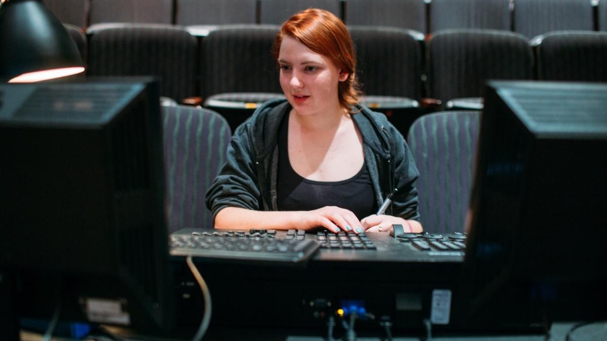 Woman working at theatre switchboard.